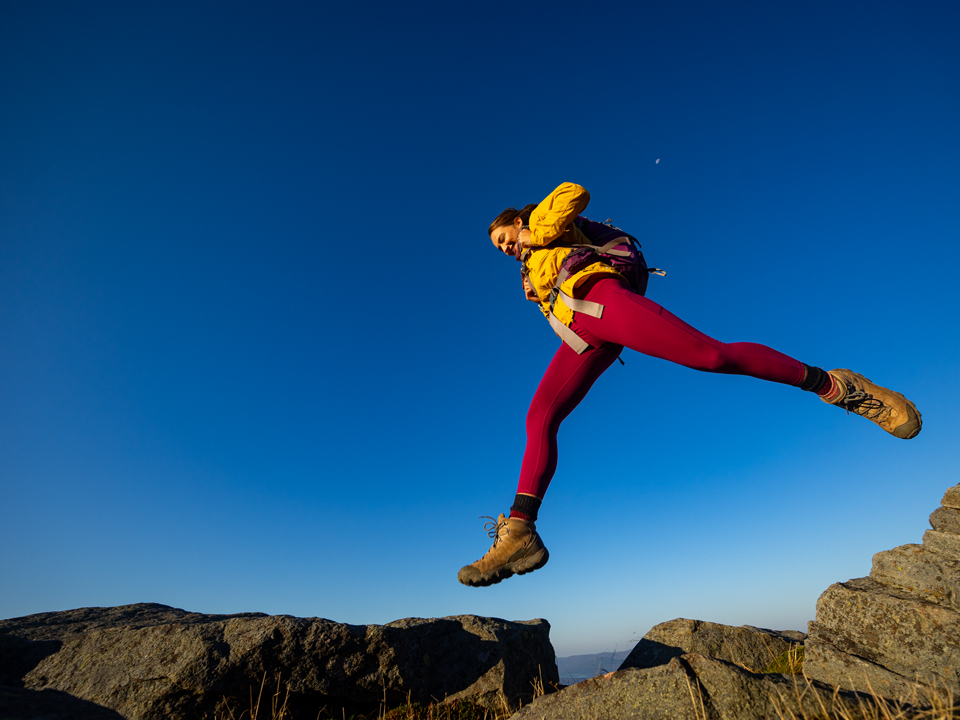 hiker jumping across rocks rollins state park