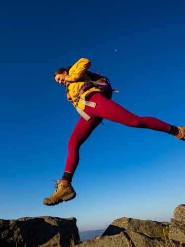 hiker jumping across rocks rollins state park