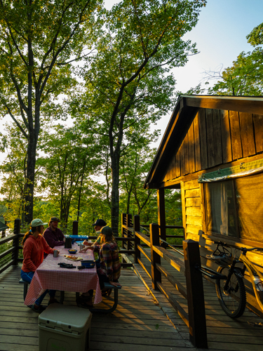 mountain bikers at bear hill cabins at bear brook state park