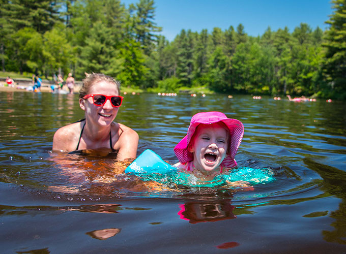 people enjoying the beach at bear brook state park