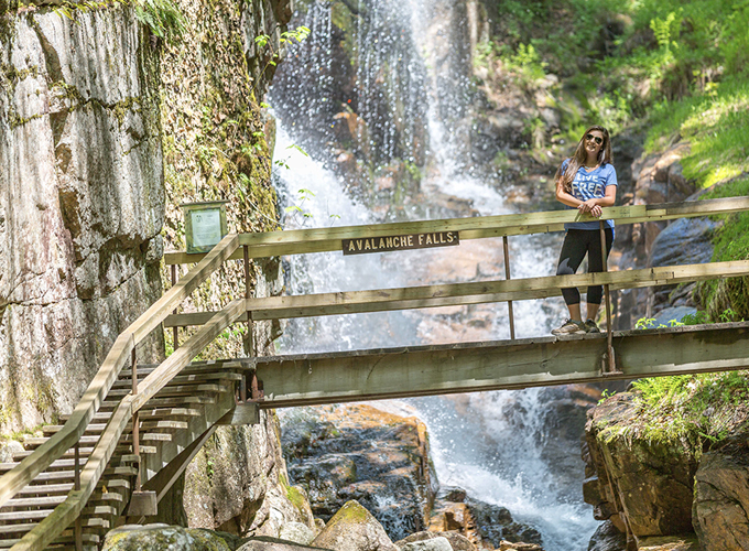 women on walkway by falls