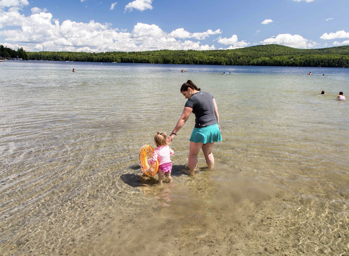 woman and child in the water in lake sunapee