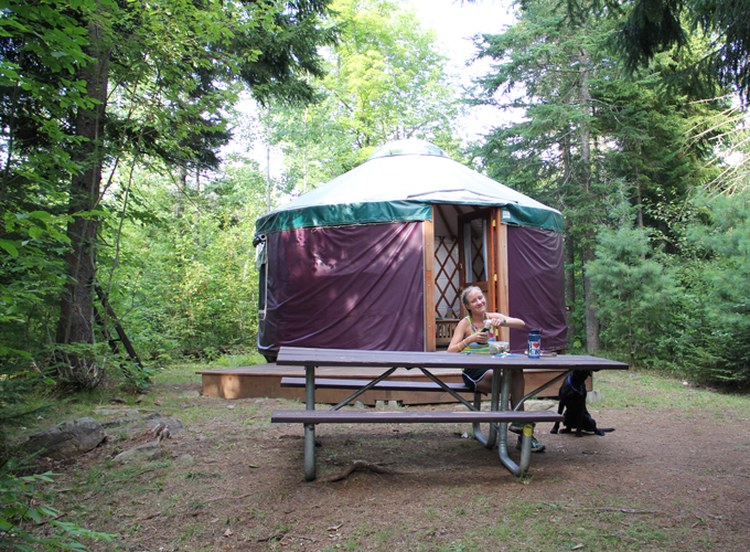 yurt at milan hill picnic table with woman eating