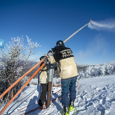 snowmakers at cannon mountain blue sky