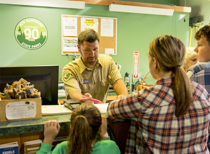 Male NH State Park employee at check-in desk