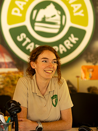 Female NH State Park employee at check-in desk
