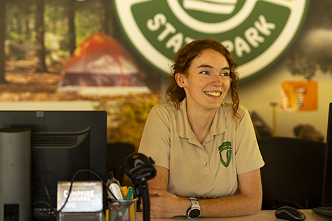 Female NH State Park employee at check-in desk