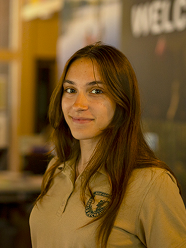 young woman employee at front desk check in 