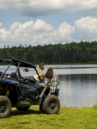 young couple ohrving taking break by a lake