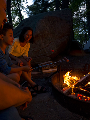 family at campfire at pawtuckaway state park