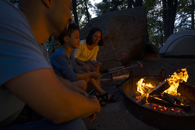 family at campfire at pawtuckaway state park