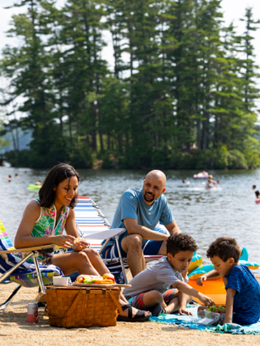 family at pawtuckaway state park beach