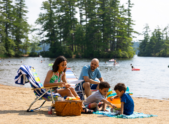 family at pawtuckaway state park beach