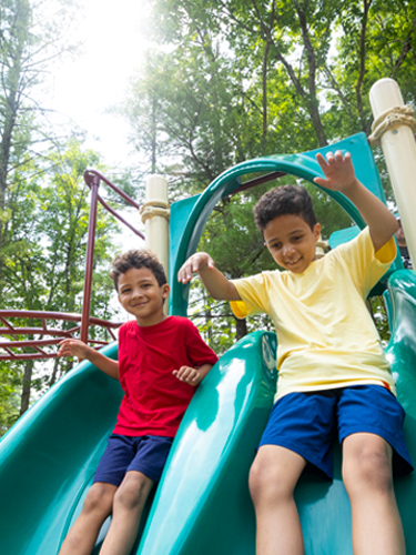 2 boys on the slide at the pawtuckaway state park playground
