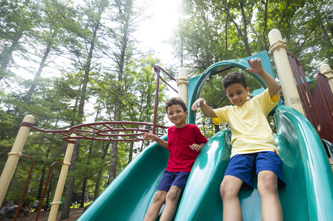 2 boys on the slide at the pawtuckaway state park playground