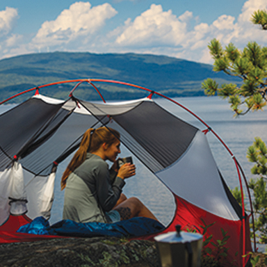 young woman camping with mt view