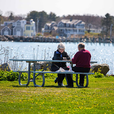 a couple running down a trail through the park