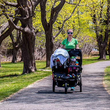 a couple running down a trail through the park