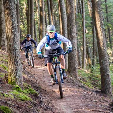 man riding bike in the woods