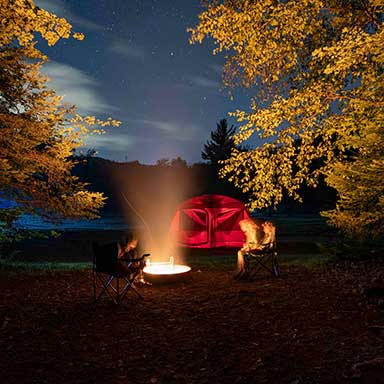 A family camping at night