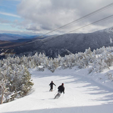 two skiers skiing at cannon mountain 