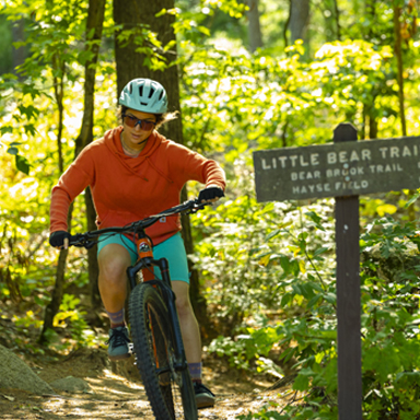 woman mountain biking at bear brook state park