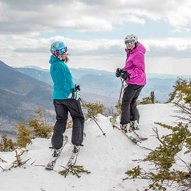 Group of people on skis atop of Cannon Mountain