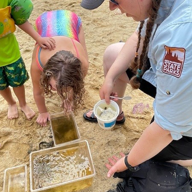 SCA Ranger doing ponding activity with kids
