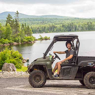 young man ohrving in great north woods