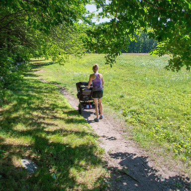 woman walking with stroller at robert frost farm