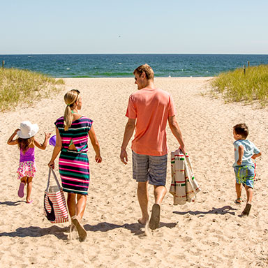 Family walking on the sand at Hampton Beach
