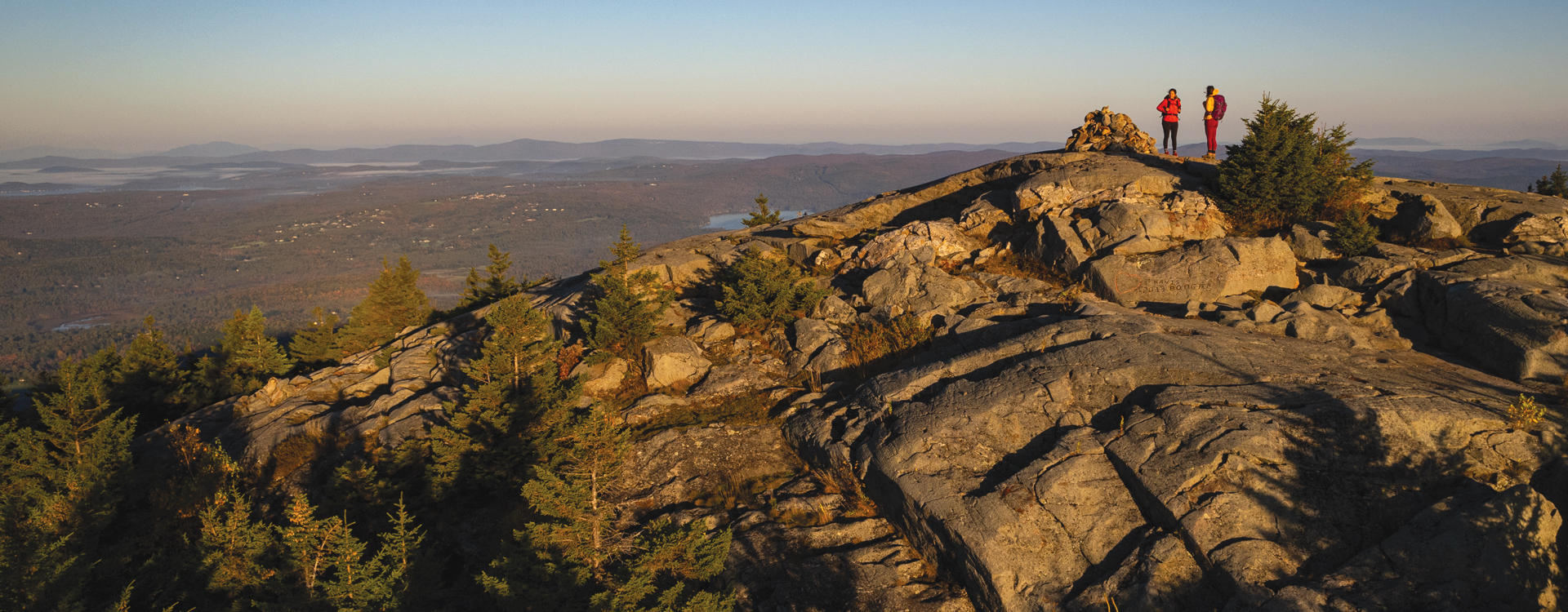 two hikers on top of mt kearsarge