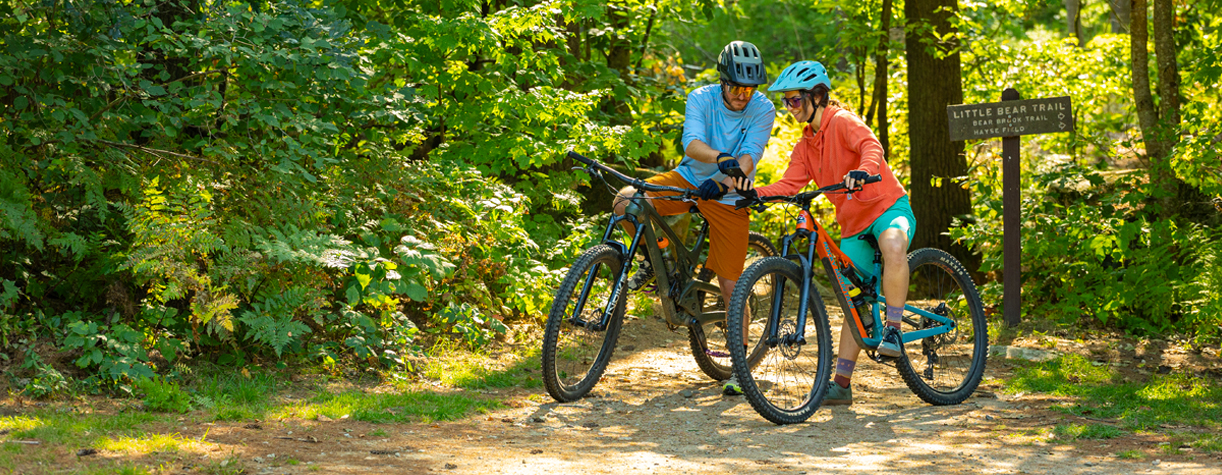 mountain bikers looking at map at bear brook state park