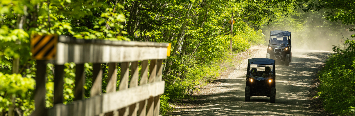 2 ATVs approaching a bridge at jericho mountain state park 