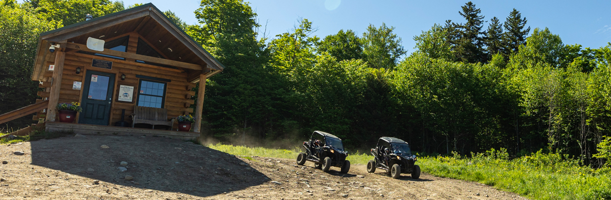 ATV riders outside of camper cabin