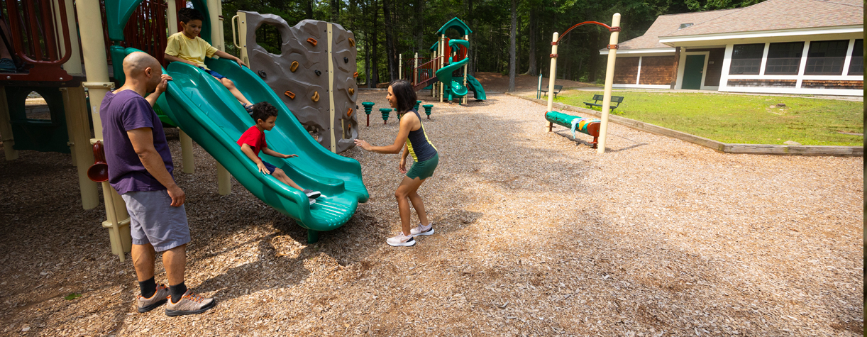 family at playground at pawtuckaway state park