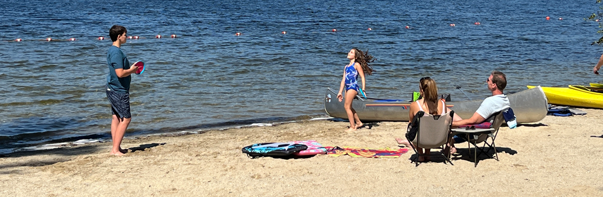 boy and girl catch at campers beach
