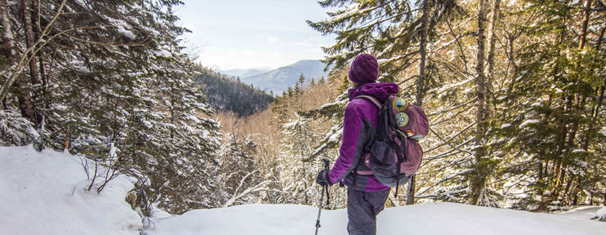 winter hiker in eagle pass at franconia notch state park