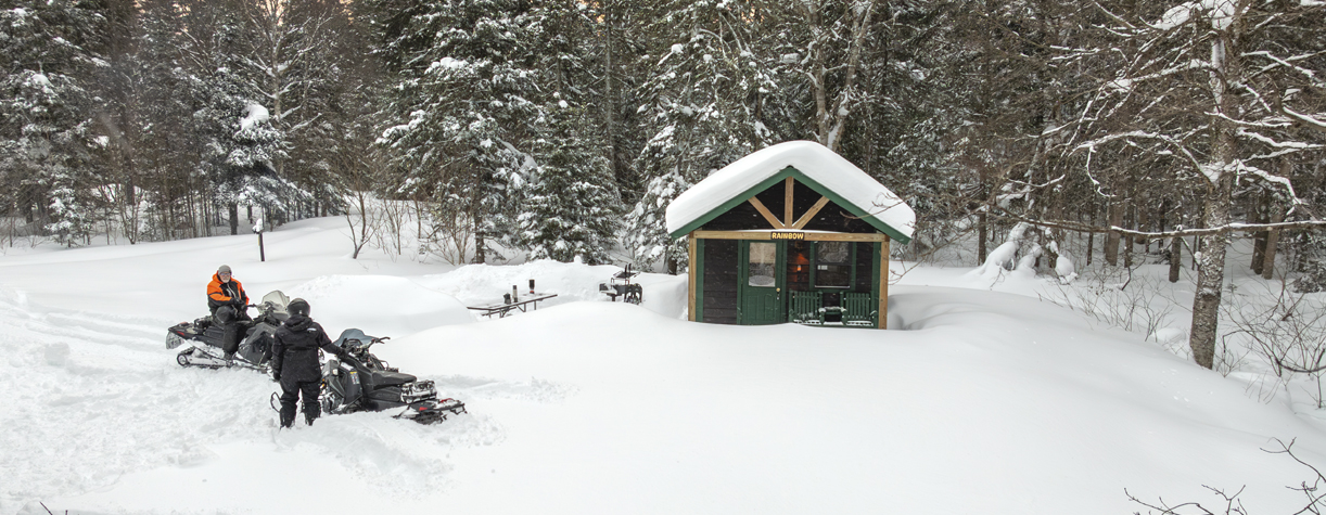 snowmobile couple at camper cabin at coleman state park