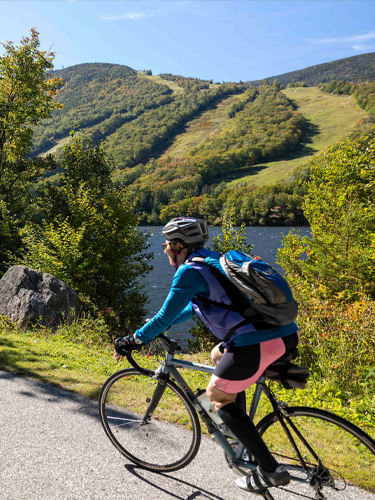 woman and child biking on franconia notch bike path