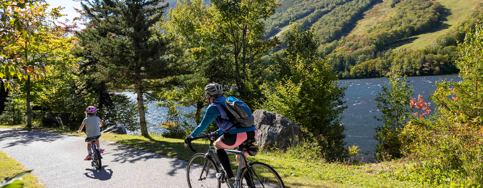 woman and child biking on franconia notch bike path