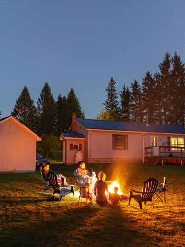 family around at campfire at coleman lodges