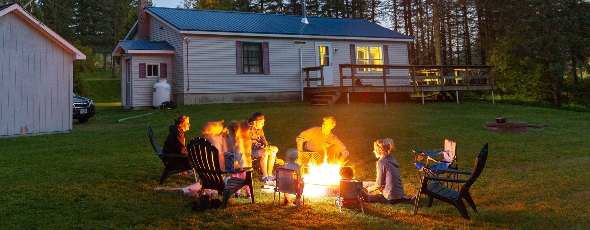 family around at campfire at coleman lodges