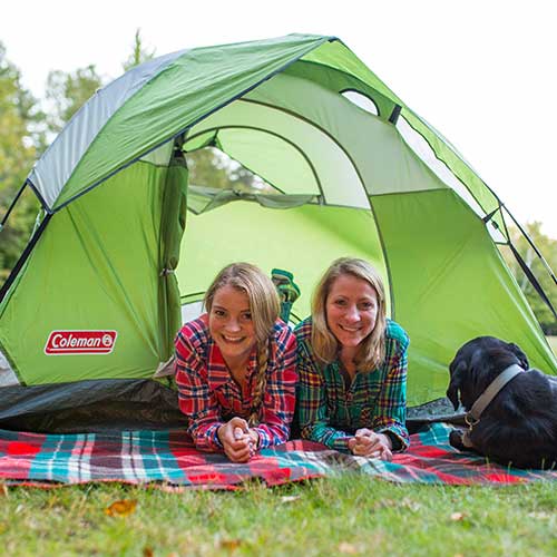 two young women at opening of tent