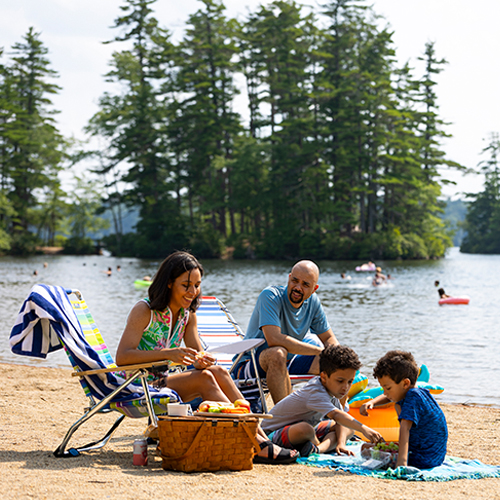 family on the beach at pawtuckaway lake 