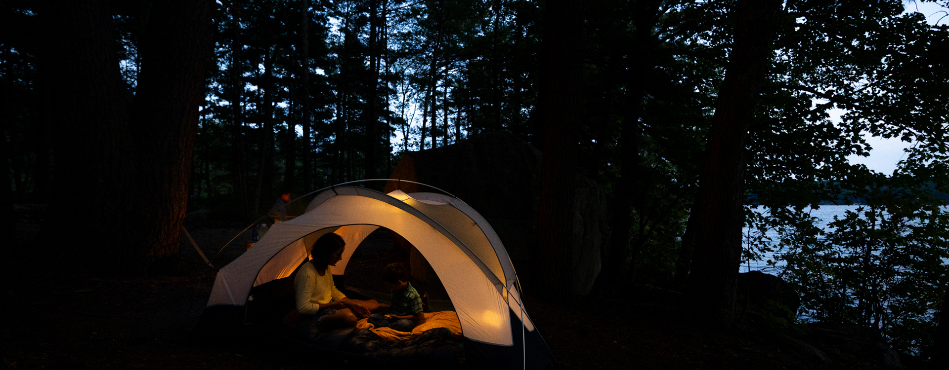 mother and son in tent at night pawtuckaway state park