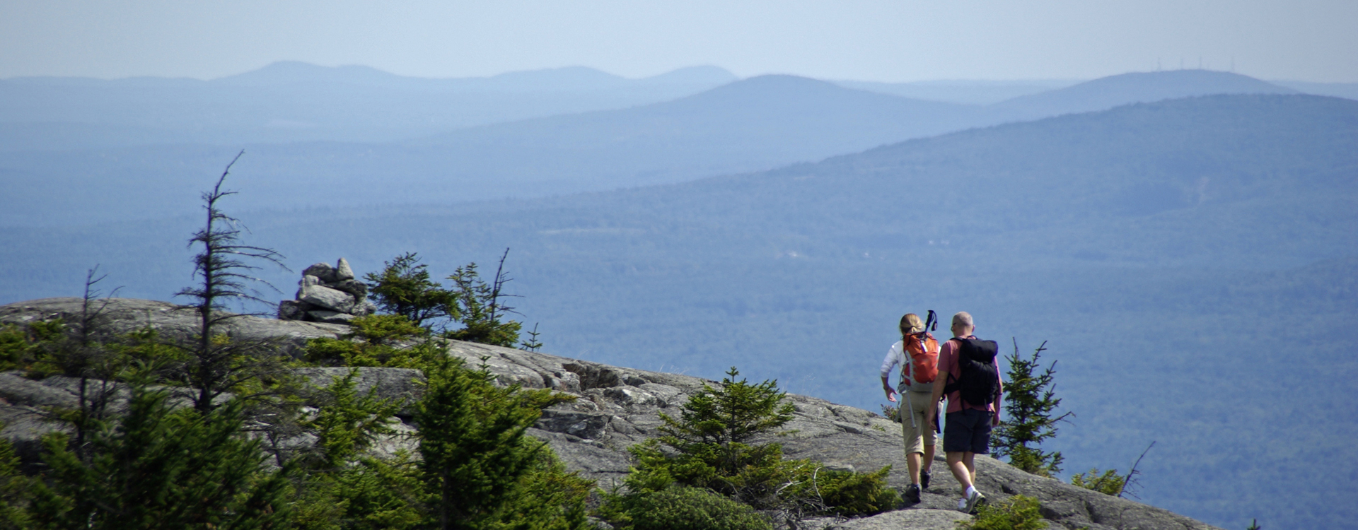 two hikers on the summit of mt monadnock