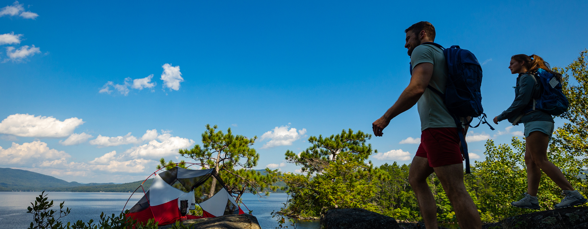 young couple hiking at wellington state park cliff island