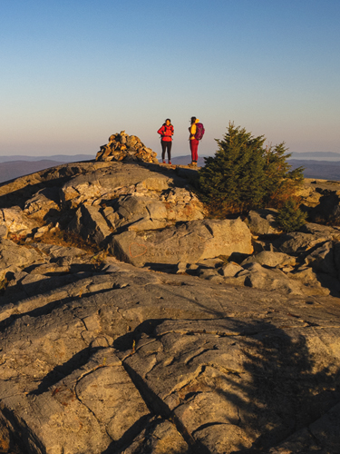 two hikers on top of mt kearsarge