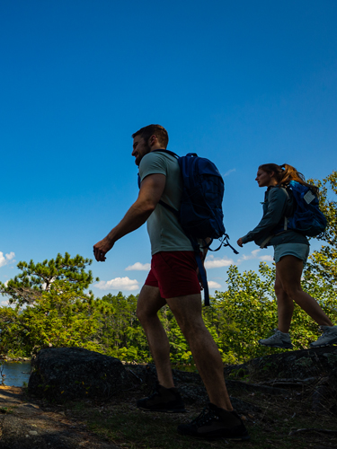 young couple hiking at wellington state park cliff island